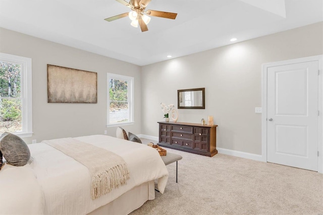 carpeted bedroom with multiple windows and ceiling fan