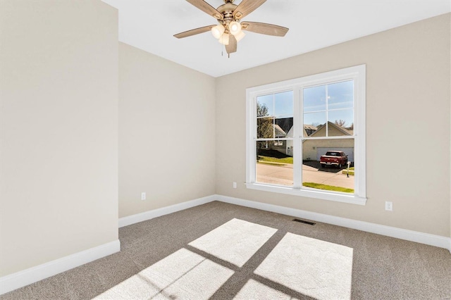 empty room with carpet and ceiling fan