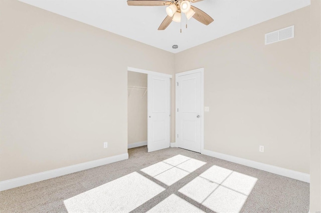 unfurnished bedroom featuring light colored carpet, ceiling fan, and a closet