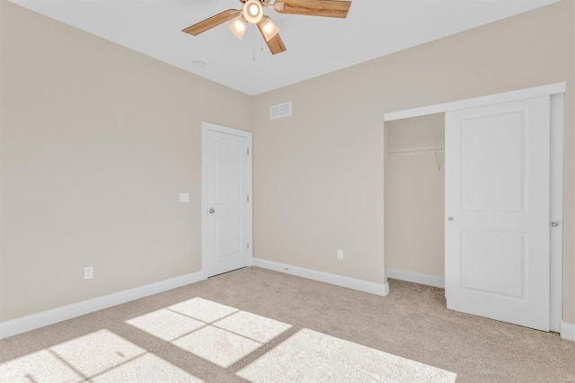 unfurnished bedroom with light colored carpet, ceiling fan, and a closet