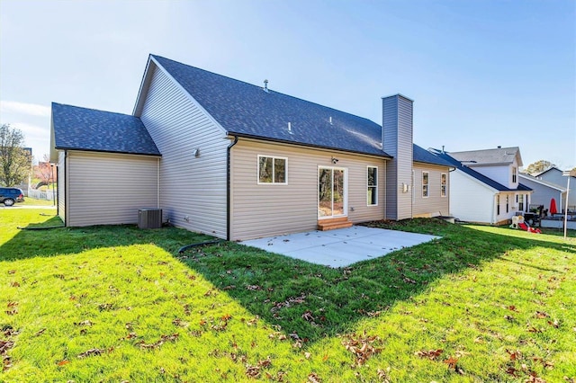 rear view of property featuring a lawn and a patio