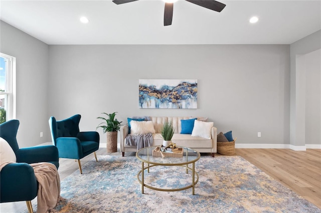 living room with hardwood / wood-style floors and ceiling fan