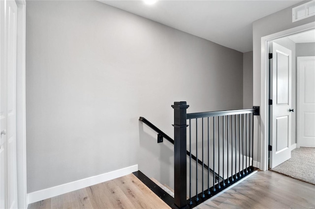 stairs with hardwood / wood-style flooring