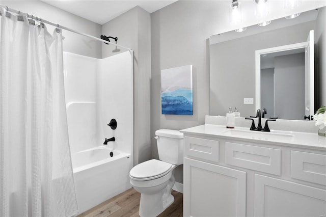 full bathroom with shower / tub combo, vanity, wood-type flooring, and toilet