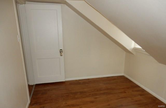 bonus room with baseboards, wood finished floors, and vaulted ceiling