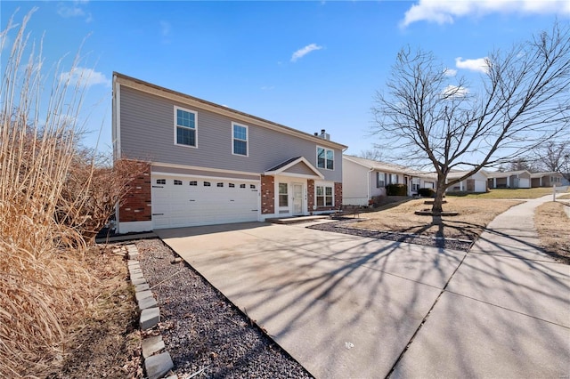 traditional home with a garage, concrete driveway, and brick siding