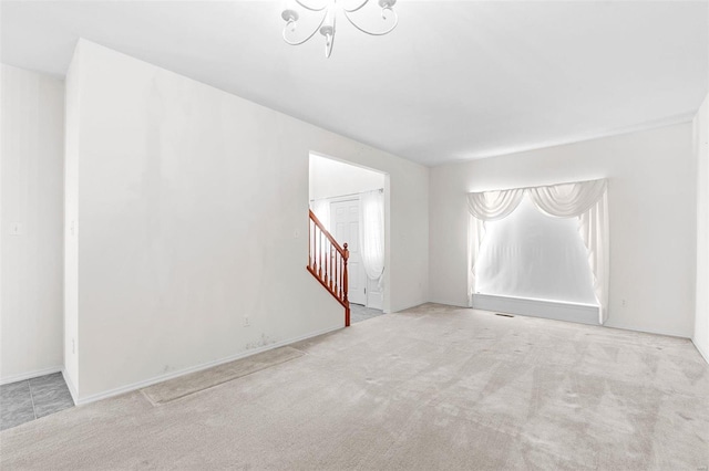 unfurnished room with light carpet