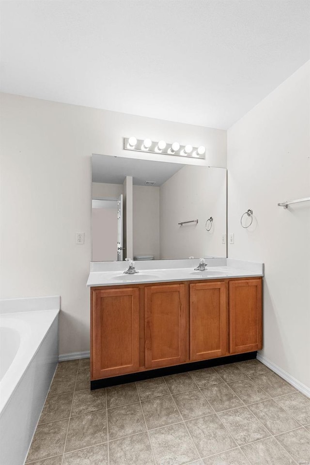 bathroom with vanity and a washtub