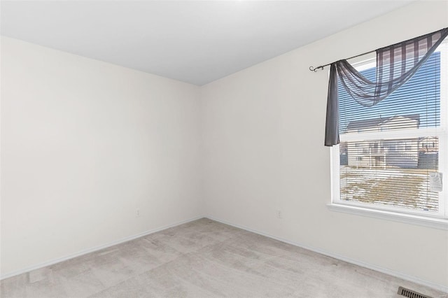 spare room with light colored carpet