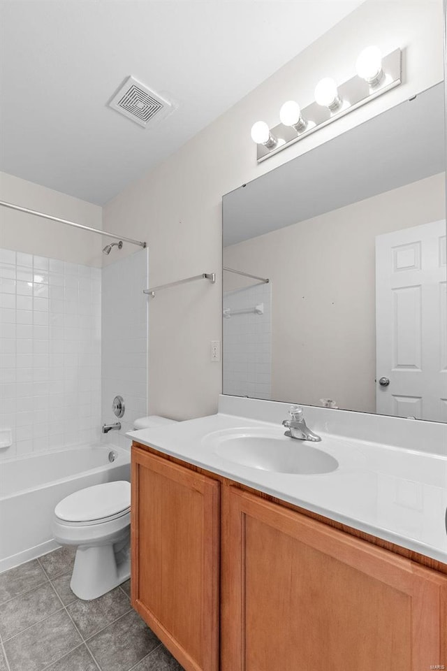 full bathroom with vanity, tiled shower / bath, tile patterned floors, and toilet