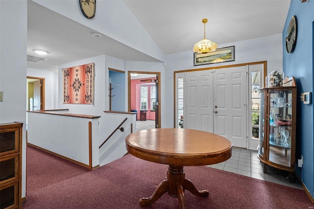 carpeted entryway featuring vaulted ceiling