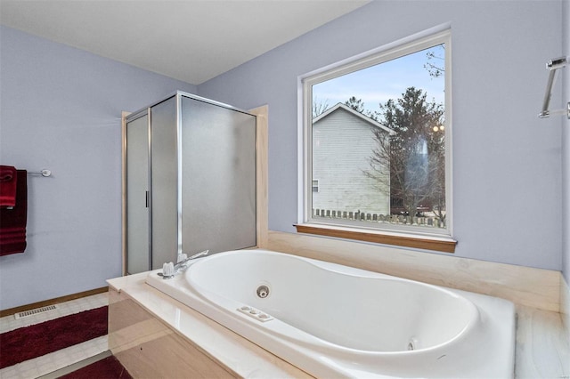 bathroom featuring independent shower and bath