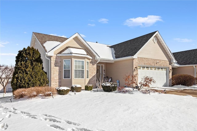 single story home with a garage and a shingled roof