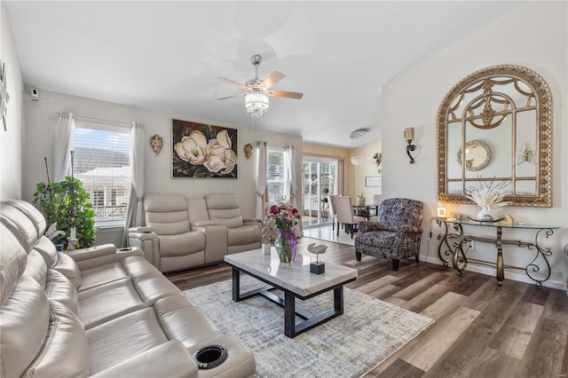 living area featuring ceiling fan, baseboards, and wood finished floors