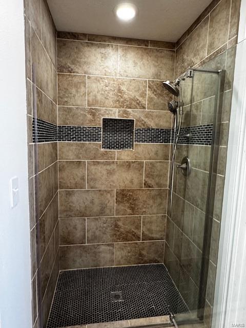 bathroom with tiled shower