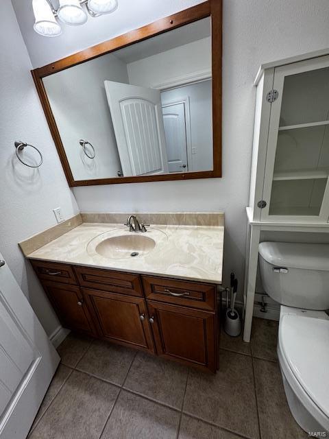 bathroom with vanity, tile patterned floors, and toilet