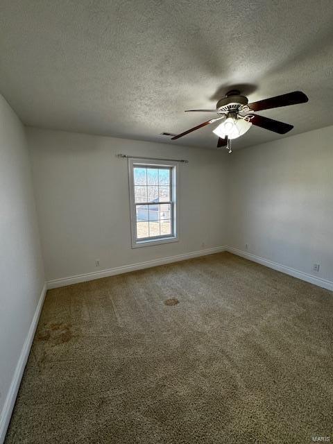 spare room with ceiling fan, carpet flooring, and a textured ceiling