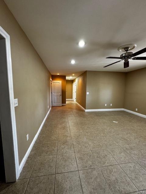 spare room featuring tile patterned flooring and ceiling fan