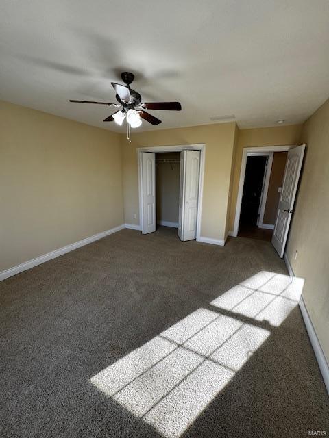 unfurnished bedroom with carpet floors, ceiling fan, and a closet