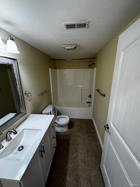 full bathroom featuring shower / bath combination, tile patterned flooring, vanity, a textured ceiling, and toilet