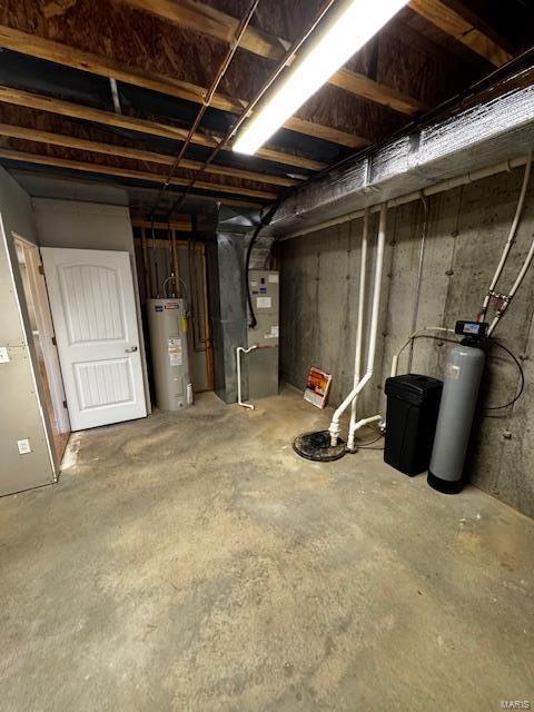 basement featuring heating unit and water heater