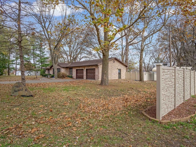 view of home's exterior with a yard and a garage