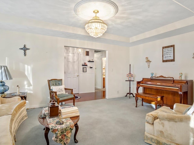 sitting room featuring an inviting chandelier and light carpet