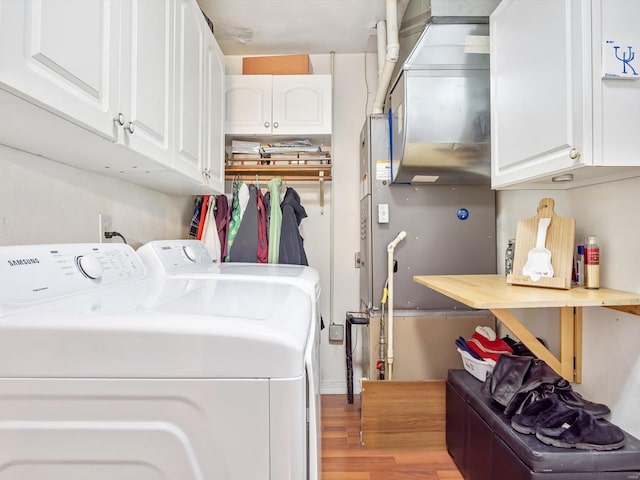 washroom with wood-type flooring and washer and dryer