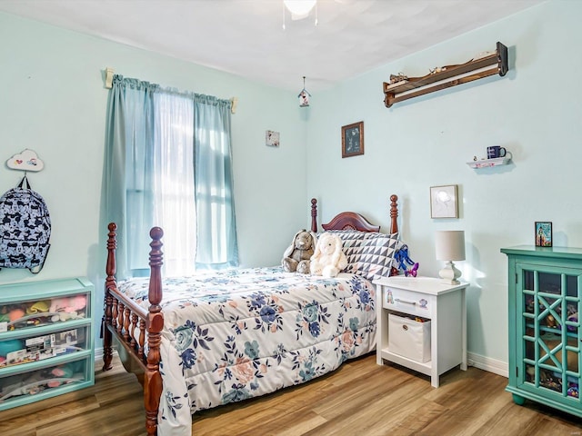 bedroom featuring wood-type flooring and ceiling fan