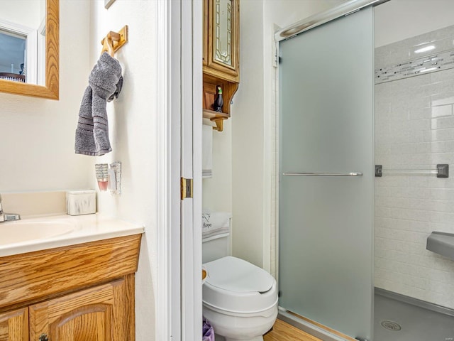 bathroom featuring walk in shower, vanity, and toilet