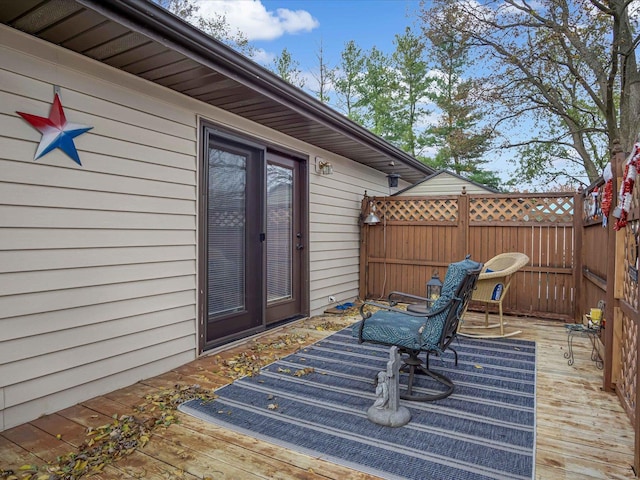 view of exterior entry with a deck