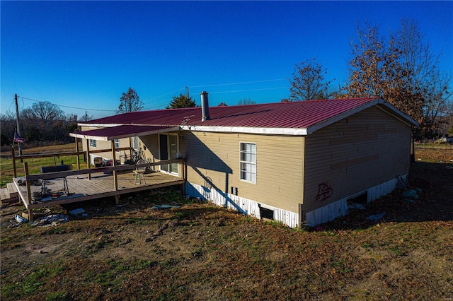 rear view of house with a wooden deck