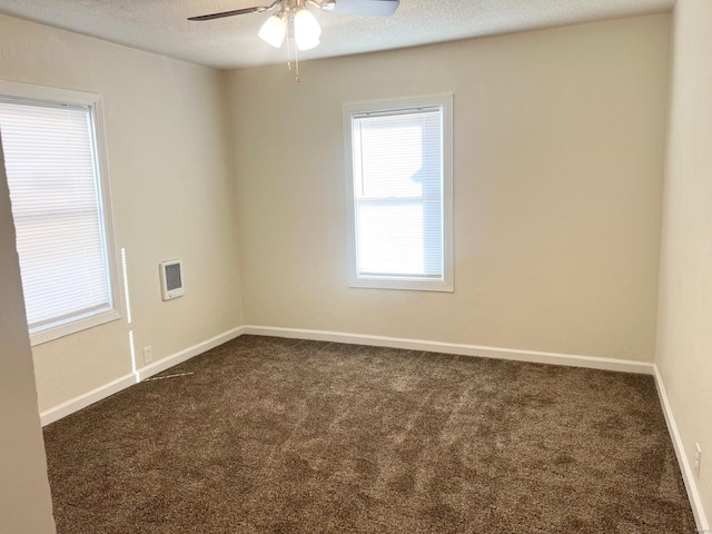 carpeted empty room featuring ceiling fan and a textured ceiling