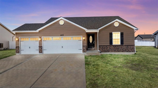 ranch-style house with a garage, brick siding, fence, a yard, and driveway