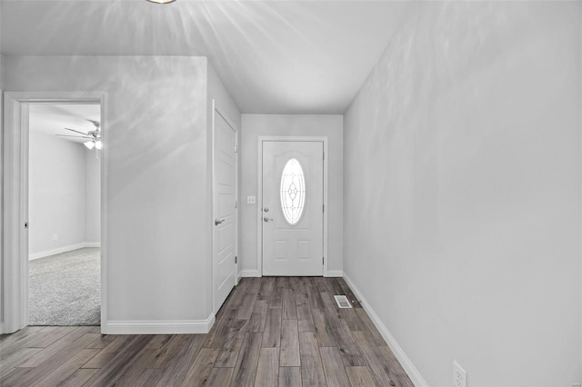 entrance foyer featuring visible vents, baseboards, and wood finished floors