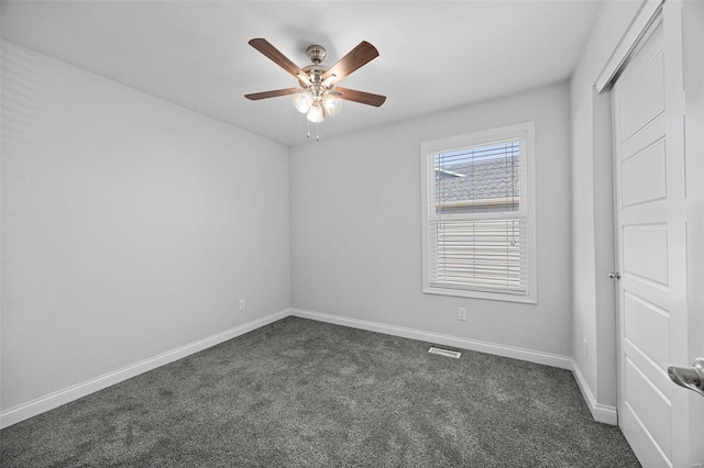 unfurnished bedroom with ceiling fan, dark colored carpet, visible vents, and baseboards