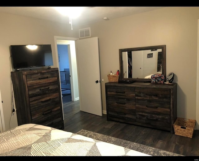 bedroom with dark hardwood / wood-style floors