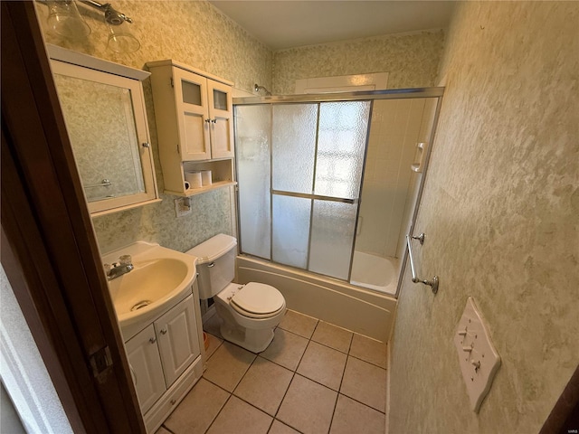 full bathroom featuring enclosed tub / shower combo, vanity, toilet, and tile patterned flooring