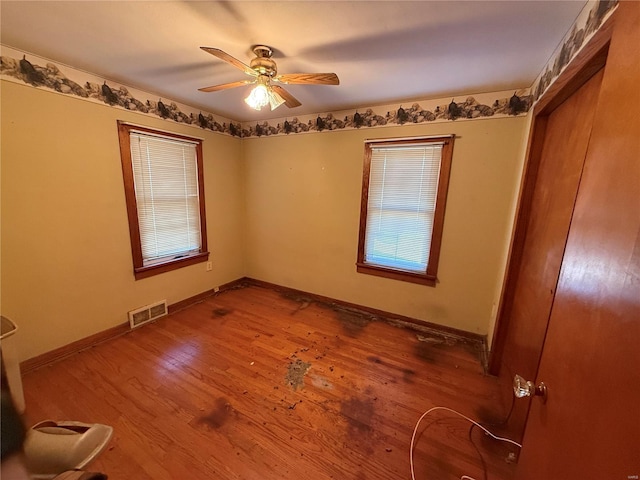 empty room with wood-type flooring and ceiling fan