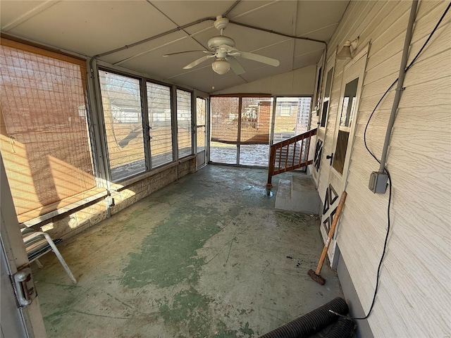 unfurnished sunroom featuring lofted ceiling and ceiling fan