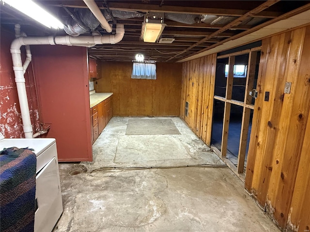 basement with wooden walls and washer / clothes dryer