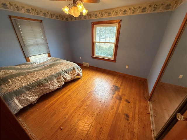 bedroom with hardwood / wood-style flooring and ceiling fan