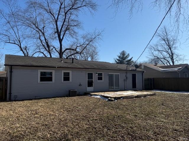 back of house featuring central AC unit, a yard, and a patio area