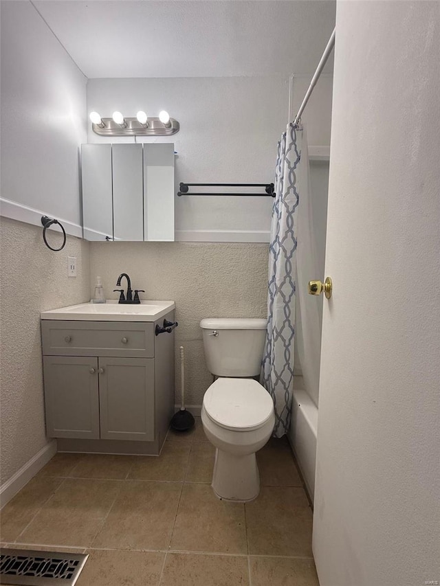 full bathroom featuring vanity, toilet, tile patterned flooring, and shower / tub combo