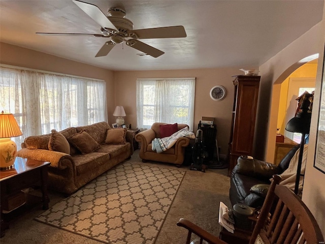 carpeted living room with ceiling fan