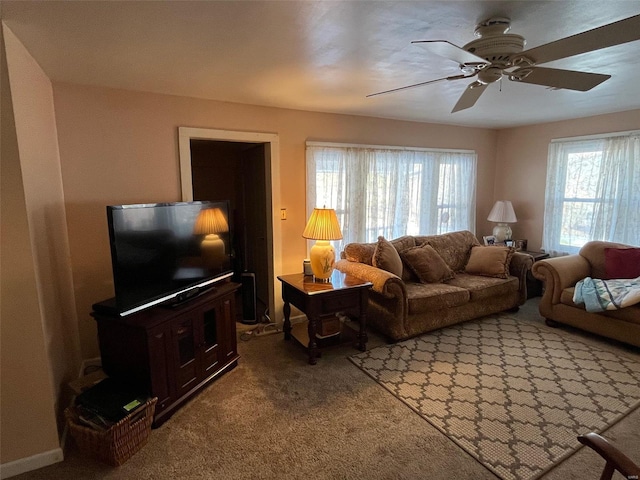 carpeted living room featuring ceiling fan