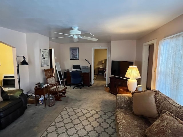 carpeted living room featuring ceiling fan