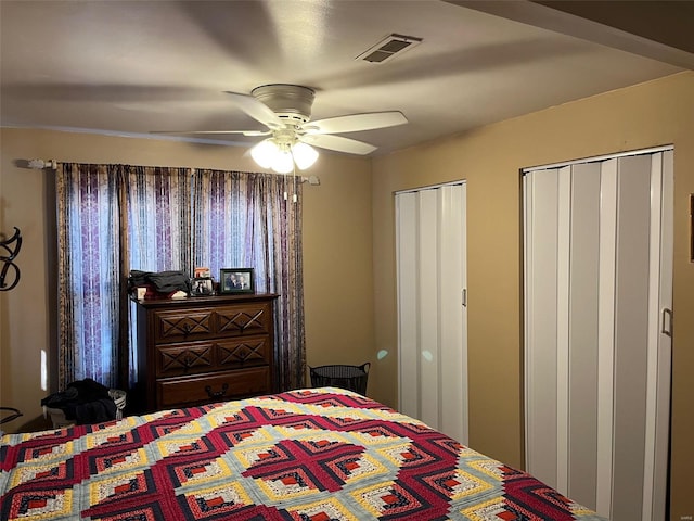 bedroom with two closets and ceiling fan