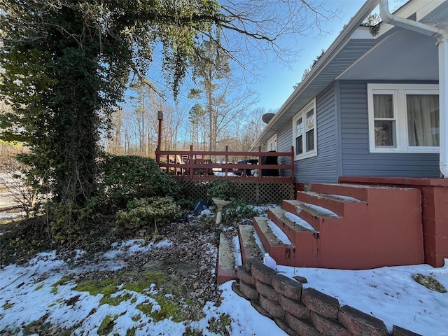 snowy yard with a deck