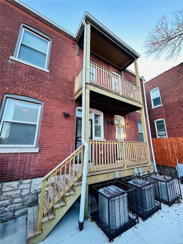 back of house featuring a balcony